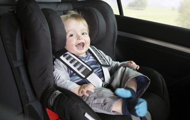 Baby boy in a child safety car seat